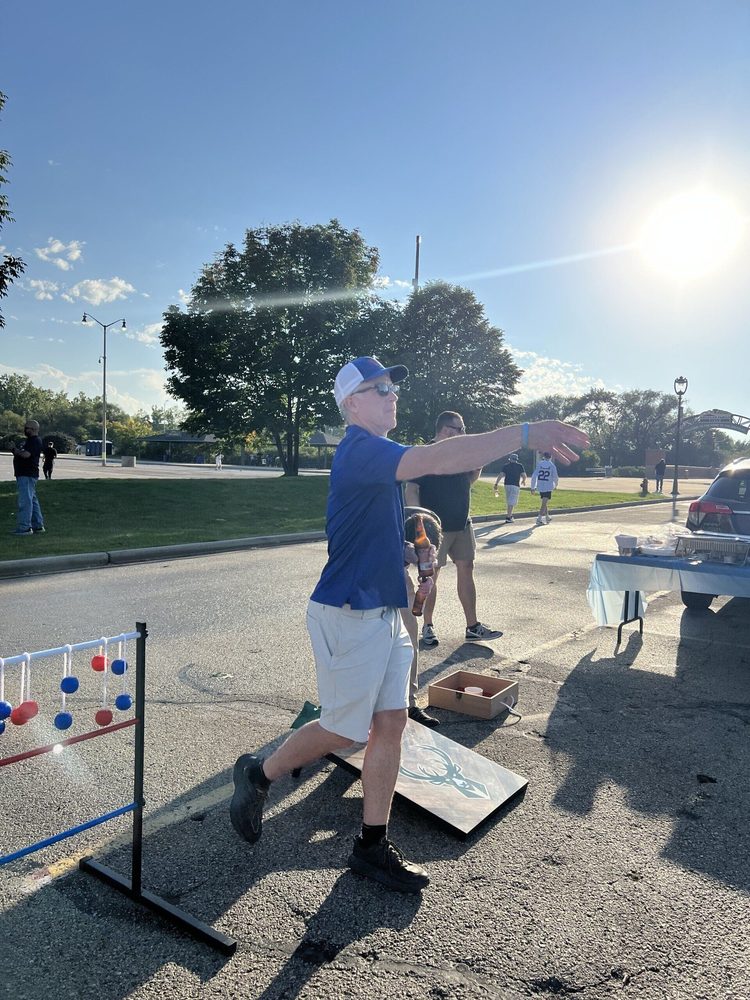 A man is throwing a frisbee in a parking lot