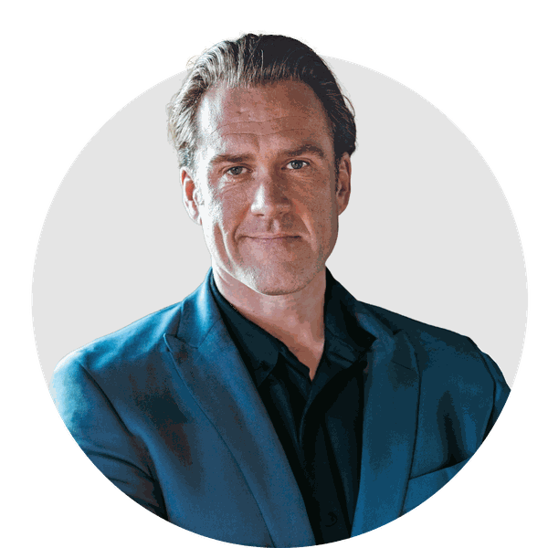 A man in a blue suit and black shirt is in a circle.