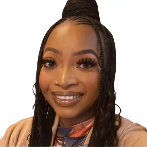 A woman with long hair is smiling in front of a white background.
