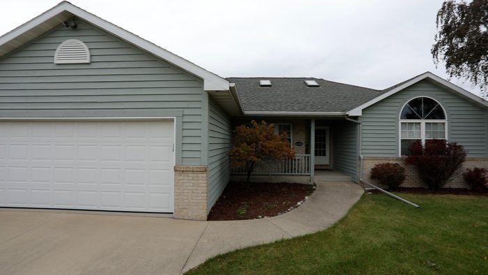 The front of a house with a white garage door